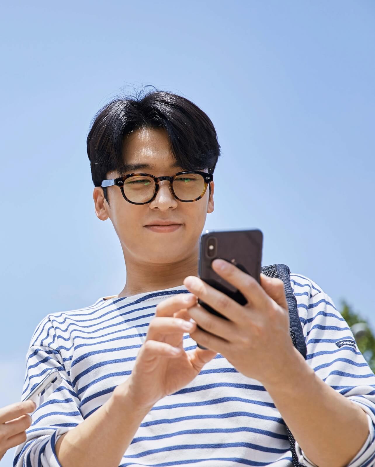 man touch smartphone with a smile